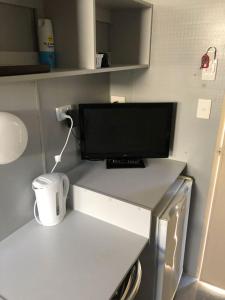 a computer monitor sitting on a counter in a kitchen at The Moonie Crossroads Hotel in Moonie +15 photos