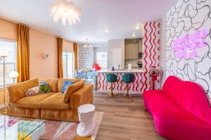 a living room with a couch and a kitchen at Near Airport, 3BR, Stock Tank Pool, Mini-Golf, Game Rm in Commerce City