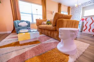 a living room with a couch and a chair at Near Airport, 3BR, Stock Tank Pool, Mini-Golf, Game Rm in Commerce City