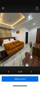 a living room with a couch and a bed at Grand Lynks Homes and Apartments in Gwarinpa