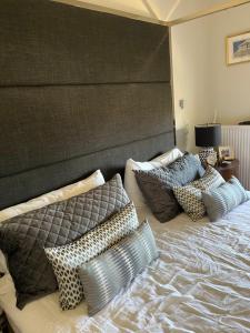 a bedroom with a large bed with pillows on it at Villa Erato in Rafina