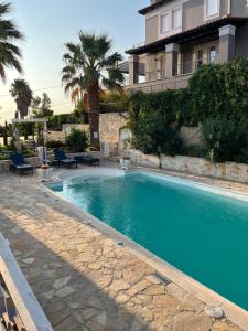 a swimming pool in front of a building at Villa Erato in Rafina