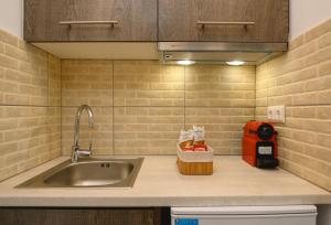a kitchen with a sink and a counter top at Louros rooms in Koufonisia +105 photos