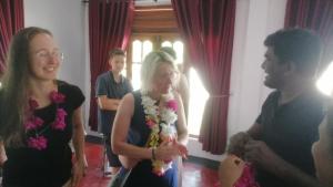 a woman is holding a bouquet of flowers at Pasikuda Shalom Echo Villa in Palayadithona