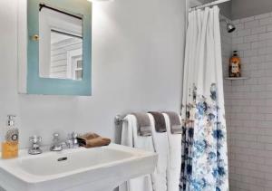 a bathroom with a sink and a shower curtain at Berkshire House Stay in Lee +27 photos