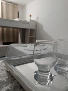 a wine glass sitting on top of a table at Hospedaria Temporarte in Piranhas