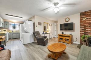 a living room with a refrigerator and a table at Condo Ideal location Ski, Shop, Hike in Conway