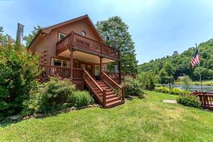 a house with a large deck on a yard at Kingfisher's Cabin 15 Minutes to Casino Hot tub Firepit in Murphy