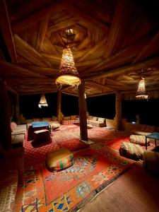 a large room with several beds and lights at Royal Sands Camp - Erg Chigaga Luxury Camp in Mhamid