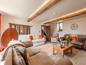 a living room with a couch and a table at The Barn in Keighley
