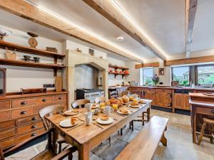 a large kitchen with a wooden table and chairs at The Barn in Keighley