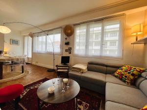 a living room with a couch and a table at Casa Boho in Angers