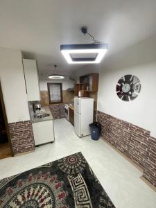 a kitchen with white appliances and a brick wall at House in Center in Skopje +7 photos