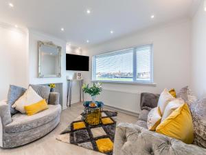 a living room with two couches and a tv at River View Cottage in Berwick-Upon-Tweed