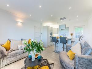 a living room with two couches and a kitchen at River View Cottage in Berwick-Upon-Tweed