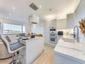 a kitchen with white cabinets and a counter top at River View Cottage in Berwick-Upon-Tweed