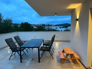 a patio with a table and chairs on a balcony at Marepromo Jezera 1 in Jezera