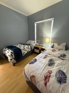 a bedroom with two beds and a mirror at Cozy Apartment with Table Mountain and beach views in Cape Town +27 photos