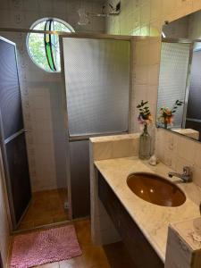 a bathroom with a sink and a shower at Pousada Holística Alto do Sol in Nova Friburgo +50 photos
