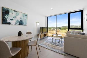 a living room with a couch and a table at Alcyone at The Corso in Maroochydore