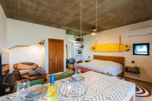 a bedroom with a bed and a table with a surfboard on the wall at Olivo in San Carlos