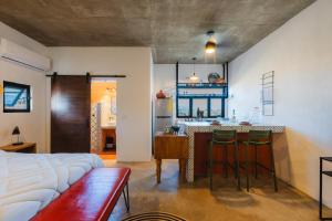 a kitchen and living room with a bar with stools at Olivo in San Carlos