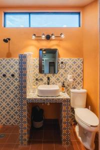 a bathroom with a sink and a toilet at Olivo in San Carlos +2 photos