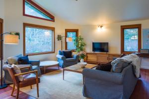 a living room with couches and a flat screen tv at Private Pond, Dog-Friendly, Peaceful, Golfing in Eastsound
