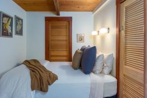 a bedroom with a white bed with blue pillows at Private Pond, Dog-Friendly, Peaceful, Golfing in Eastsound