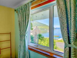 a window in a room with a view of the ocean at The Heron in Ardentinny