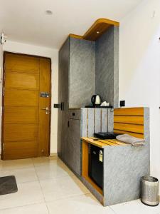 a kitchen with a counter and a wooden door at Omex hazratganj arjunganj in Nalmatha
