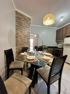 a dining room with a table and chairs and a kitchen at maray house complete elegance very well located in Formosa