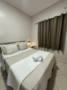 a bedroom with a bed with a towel on it at maray house complete elegance very well located in Formosa