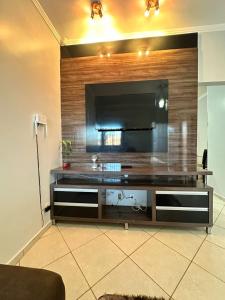 a living room with a large television on a wall at maray house complete elegance very well located in Formosa
