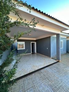 a house with a tile patio in front of it at maray house complete elegance very well located in Formosa