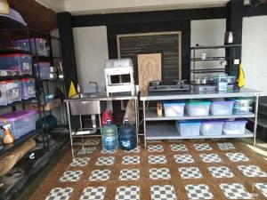 a kitchen with a counter with a sink and a microwave at Homestay Mroom Bali in Perean +6 photos