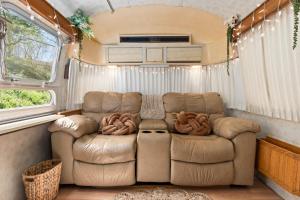 a living room in an rv with a couch at Airstream in Art's District in Asheville