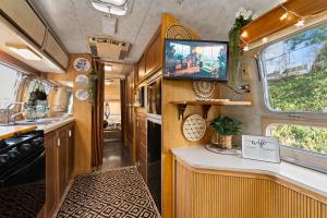 an rv kitchen with a tv and a sink at Airstream in Art's District in Asheville