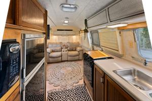 a kitchen and living room in an rv at Airstream in Art's District in Asheville +36 photos
