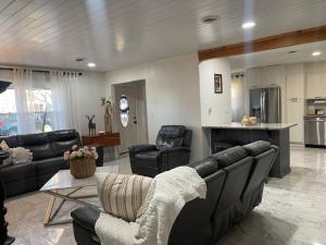 a living room with a couch and chairs and a kitchen at Beautiful house in Augusta in Augusta