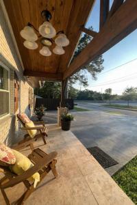 a porch with two chairs and a wooden ceiling at Beautiful house in Augusta in Augusta