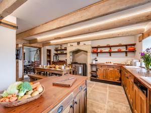 a kitchen with a bowl of vegetables on a counter at The Barn in Keighley +27 photos