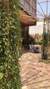 a patio with a table and chairs next to a building at Mabiti hotel in Al-ʿUla