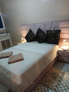 a bedroom with a large bed with pillows at Casa Ayour in Merzouga