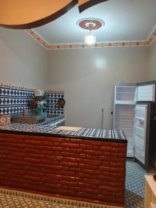 a lego kitchen with a counter top and a refrigerator at Casa Ayour in Merzouga