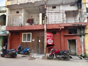 three motorcycles parked in front of a building at SPOT ON HOTEL MOONLIGHT in Bhilai