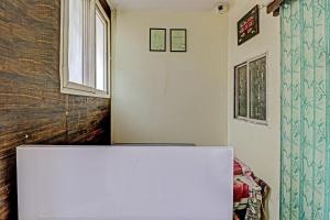 a white refrigerator in a room with a window at SPOT ON HOTEL MOONLIGHT in Bhilai