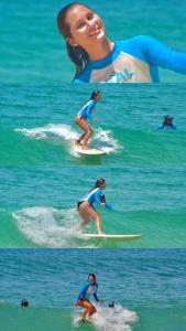 a woman riding a wave on a surfboard in the ocean at Leal Surf School in Rio de Janeiro