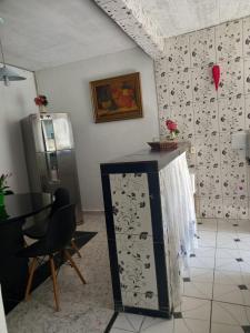 a kitchen with a refrigerator and a table in a room at Lar da Dona Judite in Pontal do Paraná +9 photos