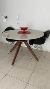 a table with two chairs and a bowl on it at Downtown apartment in Sinop +9 photos